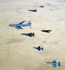 Aircraft Of The 379th Air Expeditionary Wing And Coalition Counterparts Stationed Together In A Deployed Location In Southwest Asia Fly Over The Desert Image