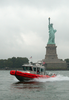 A U.s. Coast Guard Boat Patrols The In New York Harbor By The Statue Of Liberty As Part Of Their Homeland Security Mission Image