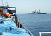 U.s. Navy Destroyer Inspects Merchant Vessel In The Arabian Gulf. Image