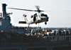 An Mh-60s Knighthawk Assigned To The  Chargers  Of Helicopter Combat Support Squadron Six (hc-6), Receives A Palette Of Supplies Aboard The Military Sealift Command (msc) Fast Combat Support Ship Usns Supply (t-aoe 6). Image