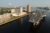 Tug Boats Guide Uss Harry S. Truman (cvn 75) Up The Elizabeth River, Past Portsmouth Landmarks, To The Norfolk Naval Shipyard Image