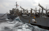 The Fast Combat Support Ship Uss Sacramento (aoe 1) Sends Cargo Over Rigging Lines While Conducting An Underway Replenishment (unrep) With The Aircraft Carrier Uss Carl Vinson (cvn 70) Image