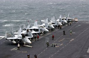 F/a-18  Hornet  And  Super Hornet  Strike Fighters Stand Ready On The Ship S Forward Flight Deck. Image
