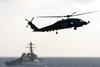 Sh-60f Seahawk Patrols The Waters Astern Of The Guided Missile Destroyer Uss Arleigh Burke (ddg 51) Image