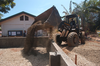 A Front Loader Assigned To The  Club And Spades  Of Naval Mobile Construction Battalion Two Five (nmcb 25), Pours Earth To Be Used In The Building Of A Foundation At The Manuel Memorial Elementary School. Image