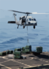An Mh-60s Knight Hawk Delivers A Crate Of Ordnance To The Military Sea Lift Command, Ammunitions Ship Usns Kiska (t-ae 35) During A Weapons Transfer From The Uss Abraham Lincoln (cvn 72) Clip Art