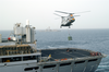 A Sailor Aboard Fast Combat Support Ship Uss Rainier (aoe 7) Attaches A Cargo Hook To A During A Recent Vertical Replenishment Image