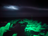 Lightning Fills The Horizon, And Lights Up The Flight Deck And Air Wing Aircraft Parked On The Ship S Forward Elevator And Bow. Image