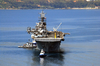 Uss Iwo Jima (lhd 7) Is Assisted By Tugs As She Arrives For A Port Visit At The Port Of Souda Bay. Image