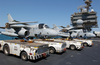 Tow Tractors Are Positioned On The Starboard Side Of The Flight Deck In Preparation For Aircraft Movement After The Conclusion Of Daily Flight Operations Aboard The Aircraft Carrier Uss Kitty Hawk (cv 63) Image