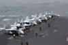 F/a-18  Hornet  And  Super Hornet  Strike Fighters Stand Ready On The Ship S Forward Flight Deck. Clip Art