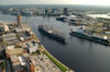 Tug Boats Guide Uss Harry S. Truman (cvn 75) Up The Elizabeth River, Past Portsmouth Landmarks, To The Norfolk Naval Shipyard Image