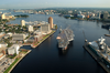 Tug Boats Guide Uss Harry S. Truman (cvn 75) Up The Elizabeth River, Past Portsmouth Landmarks, To The Norfolk Naval Shipyard Image