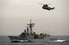 The Guided Missile Frigate Uss Nicholas (ffg 47) And A Helicopter From The Spanish Frigate Sps Navarra (f-85) Track A Simulated Cargo Vessel. Image