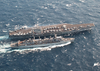 An F-14b Tomcat, From Carrier Air Wing Seven (cvw-7), Launches Off The Flight Deck Aboard Uss George Washington (cvn 73) While The Military Sealift Command (msc) Ship Usns Supply (t-aoe 6) Steams Alongside During A Replenishment At Sea. Image