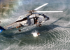 A Search And Rescue (sar) Swimmer Prepares To Jump From An Sh-60b  Seahawk  Helicopter Image
