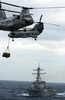 Two Ch-46d Sea Knight Helicopters Cross Paths While Transferring Cargo Image