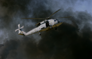 Black Smoke Clouds Rise From A Pyrotechnic Display As An Hh-60h Seahawk Helicopter Demonstrates Combat Search And Rescue (csar) For The Audience Attending The Blue Angels Homecoming Air Show At Nas Pensacola. Image