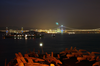 The Stern Of The Nuclear Aircraft Carrier Uss Carl Vinson (cvn 70) And The Shadow Of The Fast Combat Supply Ship Uss Sacramento (aoe 1) Are Seen Anchored Outside Of An Illuminated Hong Kong Image