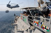 A Ch-46 Sea Knight Helicopter Attached To The Fast Combat Support Ship Uss Bridge (aoe 10), Transfers Supplies To The Guided Missile Cruiser Uss Chosin (cg 65) During A Vertical Replenishment, (vertrep) Image