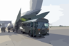 A Transport Bus From The U.s. Navy S Fleet Hospital Eight Backs Into The Tail Of A Waiting Air Force C-5 Galaxy Medical Evacuation (medevac) Plane. Clip Art