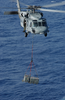 An Mh-60s Knighthawk  Transports Ammunition From The Uss Harry S.truman (cvn 75) To The Military Sealift Command Ammunition Ship Usns Mount Baker (t-ae 34) During An Ammo Off-load Image