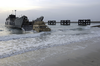 A High Mobility Multi-purpose Wheeled Vehicle (hmmwv) Roles Off Of A Landing Craft Utility (lcu) From The Uss Tarawa (lha 1) Amphibious Ready Group (arg) Image