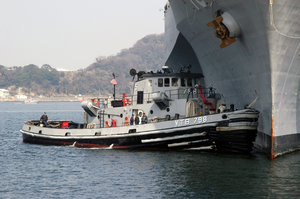 A Large Harbor Tug Uss Opelika (ytb 798) Assists Amphibious Command And Control Ship Uss Blue Ridge (lcc 19) To Its Berth After A Scheduled Deployment In The Western Pacific Image