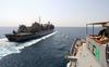 The Guided Missile Cruiser Uss Chosin (cg 65) Prepares To Come Alongside The Fast Combat Support Ship Uss Bridge (aoe 10) In Preparation Of An Underway Replenishment Image