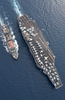 The Military Sealift Command (msc) Combat Stores Ship Usns Spica (t-afs 9) Steams Alongside The Nuclear Powered Aircraft Carrier Uss Harry S. Truman (cvn 75). Image