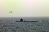 An Sh-60 Seahawk Roves The Surrounding Area After A Rigid Hull Inflatable Boat (rhib) From Uss Nimitz (cvn 68) Picks Up An Emergency Medical Patient From The Attack Submarine Uss Pasadena (ssn 752) Image