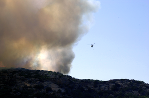 An Italian Helicopter Assists In U.s. Navy Fire Fighting Efforts On The Island Of Santo Stefano Image