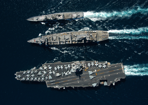 The Guided Missile Cruiser Uss Gettysburg (cg 64), Top, And The Aircraft Carrier Uss Enterprise (cvn 65), Bottom, Underway Alongside The Fast Combat Support Ship Uss Detroit (aoe 6) . Image