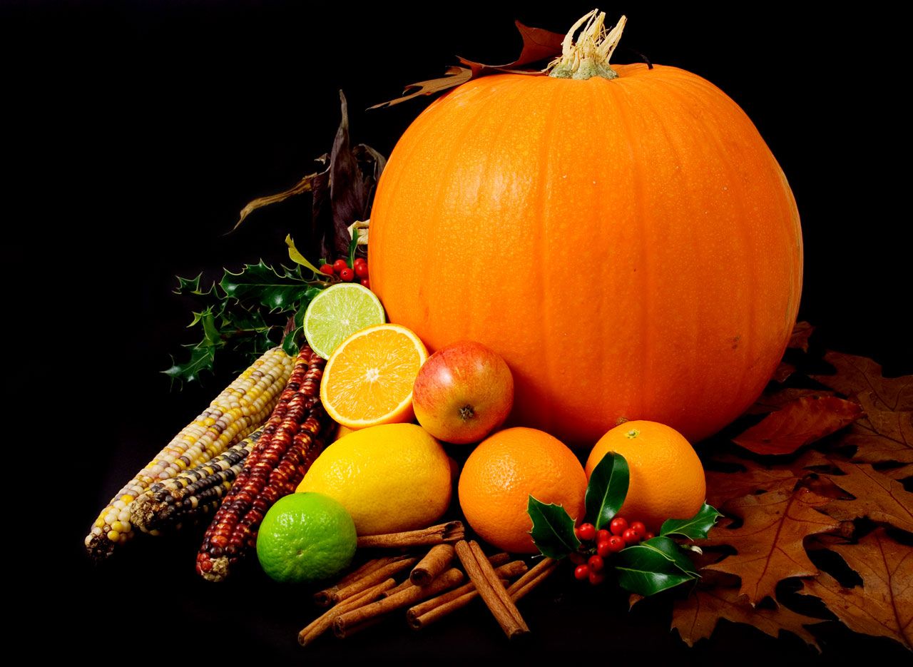 Still Life Picture Of A Pumpkin And Other Various Fruit On Black