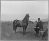 Man Sitting Infront Of Horse Image