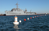 A Newly Installed Buoy-based Security Barrier Stretches Around The Amphibious Transport Dock Ship Uss Denver (lpd 9) As The Ship Takes On Ammunition. Image