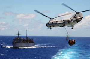 A Ch-46d Sea Knight  Lifts A Full Load From The Aircraft Carrier Uss Carl Vinson (cvn 70) To The Fast Combat Support Ship Uss Sacramento (aoe 1), While The Guided Missile Cruiser Uss Antietam (cg 54) Follows Close Behind Image
