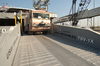 United States Army Vessel (usav) Theater Support Vessel Spearhead (tsv-1x) Off-loads An Army Fire-fighting Vehicle While Pier-side At A Port Within The Central Command Aor. Image