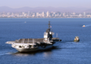 A Tugboat Tows The Decommissioned Aircraft Carrier Midway Into San Diego Bay. Image