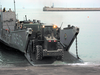 U.s. Army Personnel Assigned To The 567th Transportation Company Offload Water And General Military Supplies From A U.s. Navy Landing Craft Utility (lcu) Image