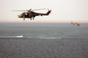 A British Royal Navy Gkn Westland Lynx Hma Mk. 8 Helicopter Acts As Plane Guard For An Mh-53 Sea Dragon Helicopter Assigned To The  Vanguards  Of Helicopter Mine Countermeasures Squadron Fourteen (hm-14). Image