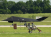 A Wright B Flyer Replica Taxis Past A United States Air Force F-117a Stealth Fighter During The U.s. Air And Trade Show. Clip Art