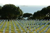 A Tugboat Tows The Decommissioned Aircraft Carrier Midway Past Fort Rosecrans National Cemetery To San Diego Bay. Image