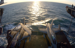 An Ea-6b And An F/a-18c Are Raised To The Flight Deck On One Of Four Aircraft Elevators Aboard Uss Kitty Hawk (cv 63) Image