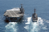 Guided Missile Destroyer Uss John Paul Jones (ddg 53) Pulls Along Side Uss John C. Stennis (cvn 74) During An Underway Replenishment Image