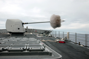 A 54 Caliber Mk-45 Five-inch Gun Fires A Projectile Off The Ship S Starboard Side Image