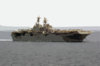 The Amphibious Assault Ship Uss Iwo Jima (lhd 7) Cruises Alongside Uss Nimitz (cvn 68) Clip Art